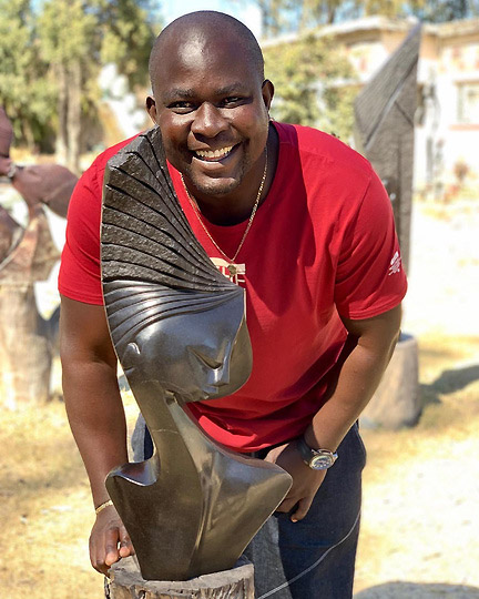 Lovemore Bonjisi with his sculpture