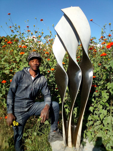 Prosper Katanda with his sculpture
